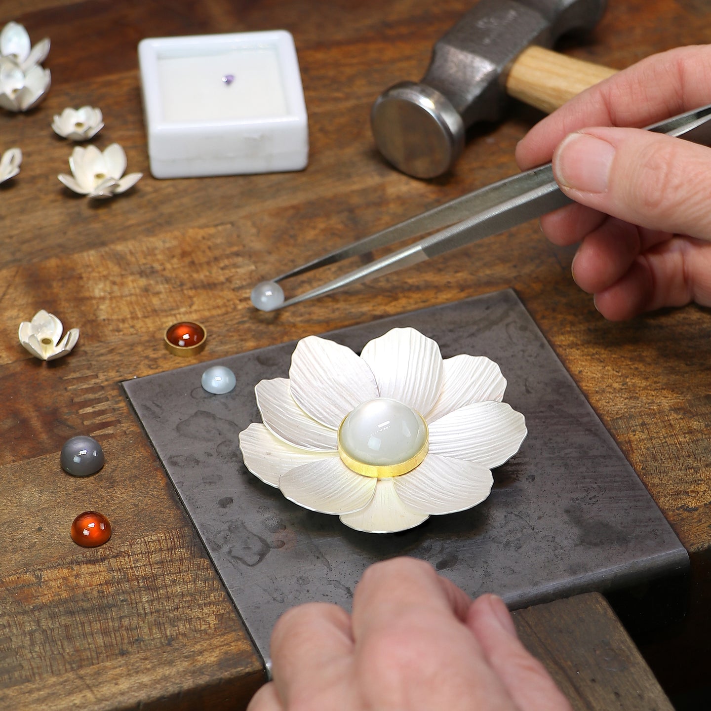 Handmaking custom jewelry with tools at the jeweler's bench